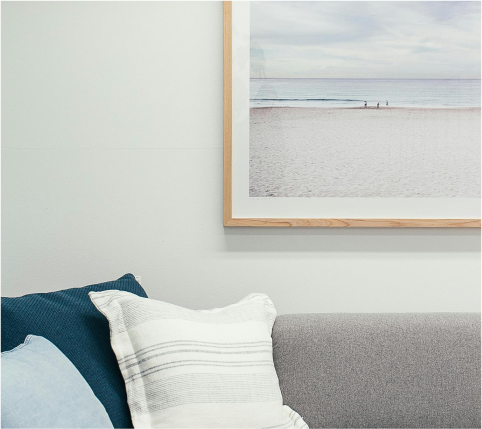 Framed photo displayed above a seating area, adding a decorative touch to the space.