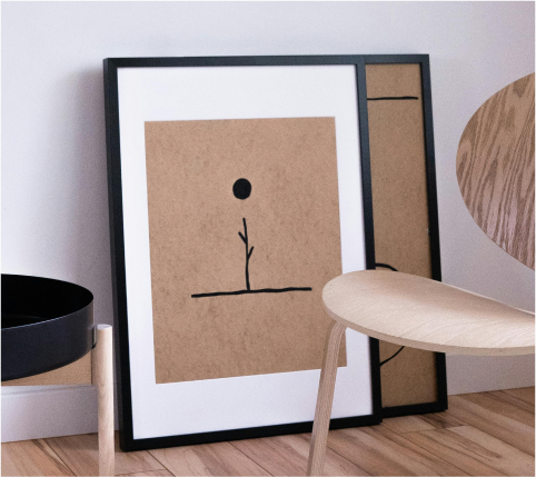 Two framed photos prepared to be hung on a wall, ready for display.