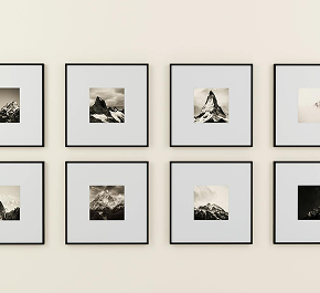 Square frames with small black borders arranged on a wall, creating a minimalist display.