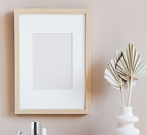 Paper-sized frames with light-colored wooden borders, neatly arranged for display.