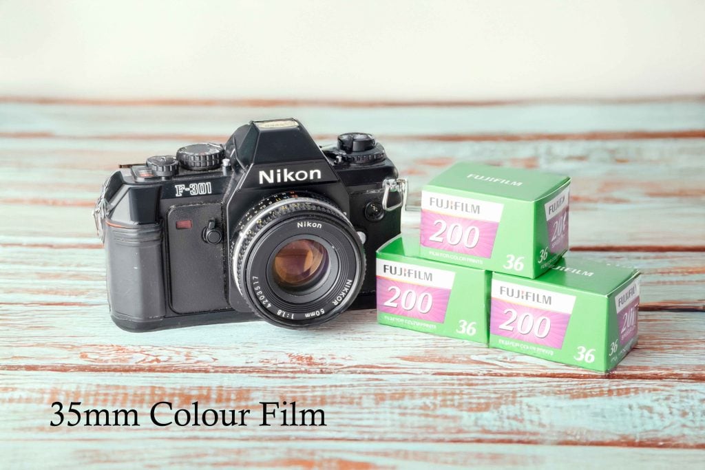 Nikon camera with text indicating it uses 35mm color film, highlighting analog photography equipment.