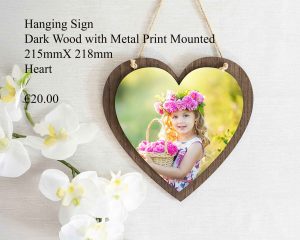 Heart-shaped hanging sign made of dark wood with a mounted metal print, measuring 215mm x 218mm.