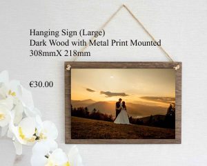 Large wooden hanging sign in dark wood with a metal print mounted on it, ready for display.