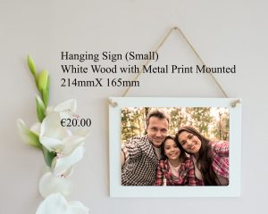 Small hanging sign made of white wood with a mounted metal print, measuring 214mm x 165mm.