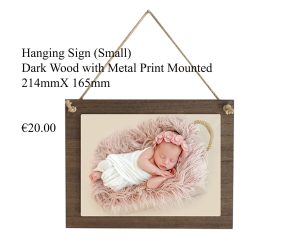 Small hanging sign made of dark wood with a mounted metal print, measuring 214mm x 165mm.