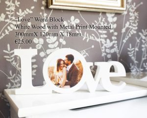 "Love" word block made of white wood with a mounted metal print, measuring 300mm x 120mm x 18mm.