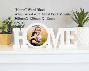 "Home" word block made of white wood with a mounted metal print, measuring 300mm x 120mm x 18mm.